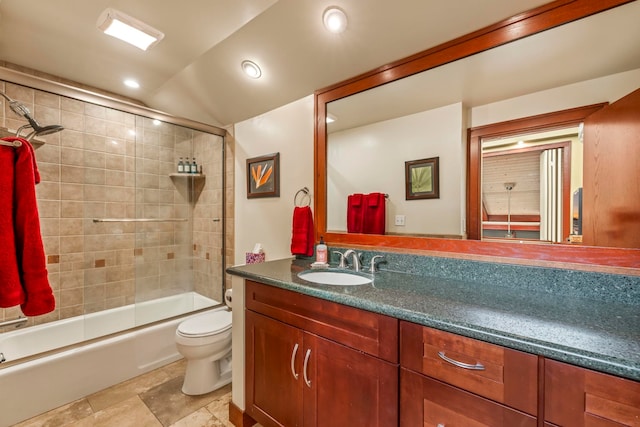 full bathroom featuring vaulted ceiling, shower / bath combination with glass door, vanity, and toilet