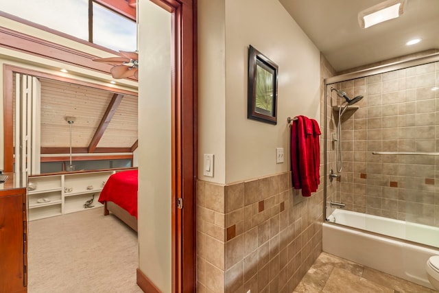 bathroom featuring ceiling fan, bath / shower combo with glass door, tile walls, vaulted ceiling with beams, and toilet