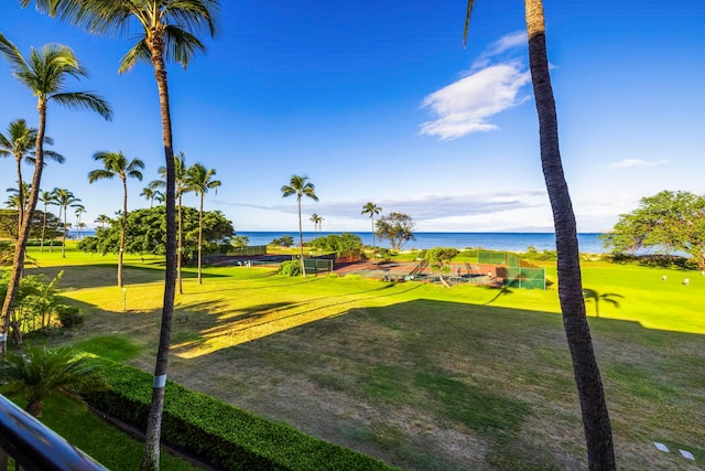 view of property's community with a water view and a yard