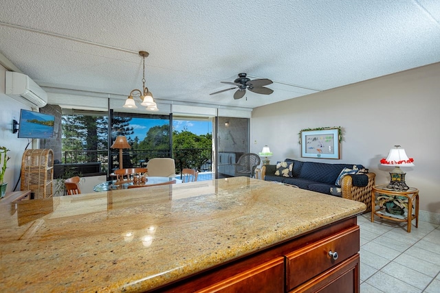 kitchen featuring a textured ceiling, light stone countertops, ceiling fan with notable chandelier, and a wall mounted air conditioner