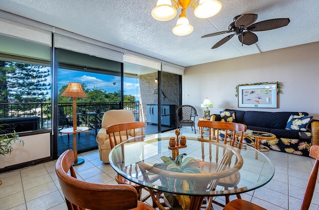 dining room featuring floor to ceiling windows, ceiling fan, light tile flooring, and a textured ceiling