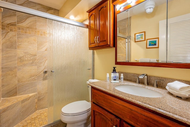 bathroom featuring walk in shower, oversized vanity, and toilet