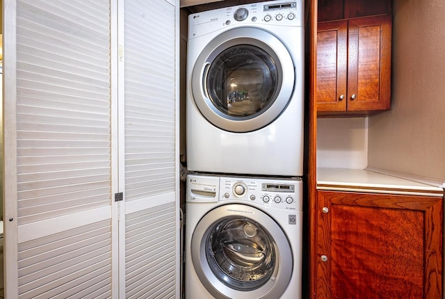 laundry room featuring stacked washer / drying machine