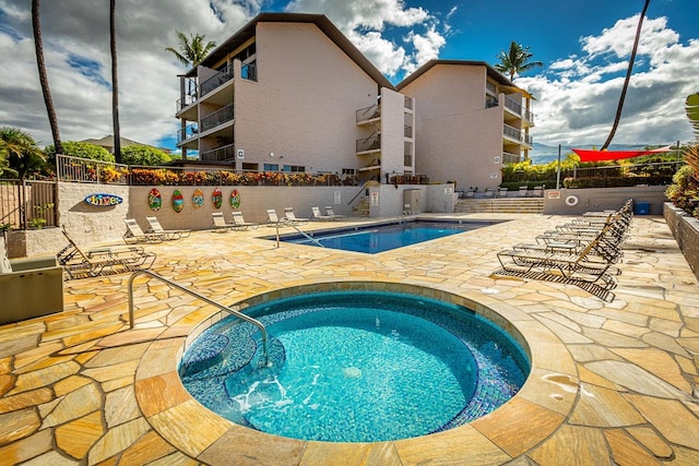 view of pool featuring a hot tub