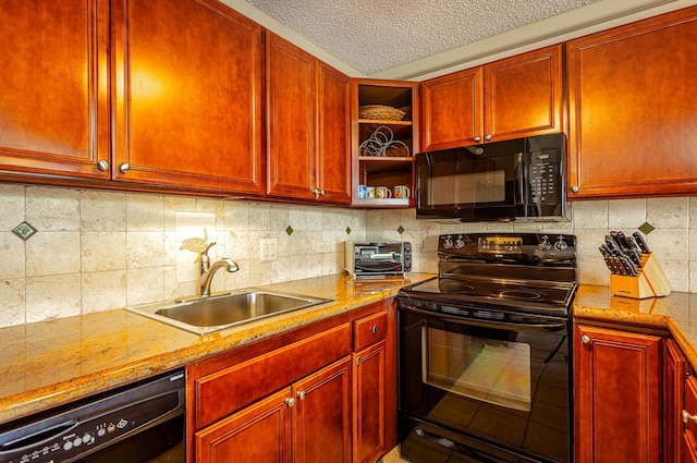 kitchen with black appliances, light stone counters, a textured ceiling, backsplash, and sink