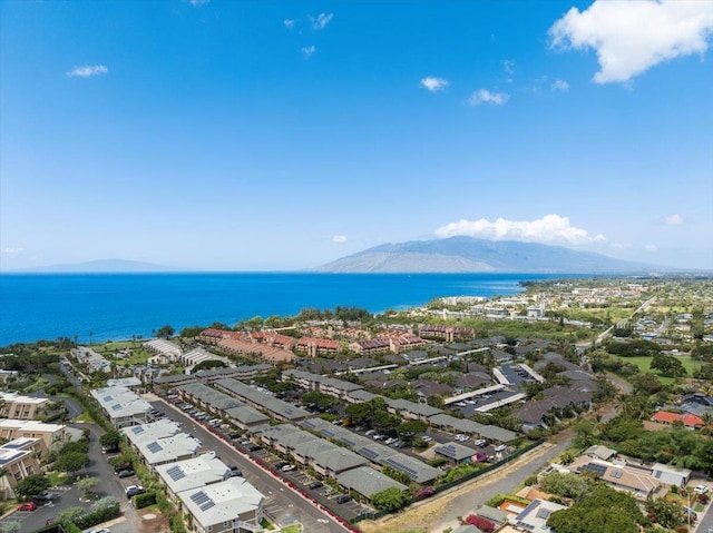 birds eye view of property with a water and mountain view