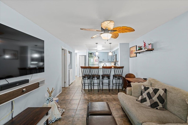 tiled living room with a ceiling fan