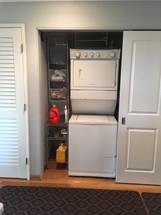 44 Kanani Rd Unit 1-104, Kihei, HI 96753 - laundry room with estacked washer and dryer and wood finished floors