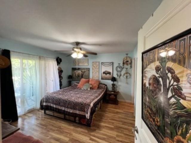 44 Kanani Rd Unit 1-104, Kihei, HI 96753 - bedroom with wood finished floors and ceiling fan