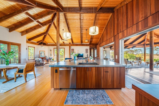 kitchen featuring wooden ceiling, sink, stainless steel dishwasher, decorative light fixtures, and beam ceiling