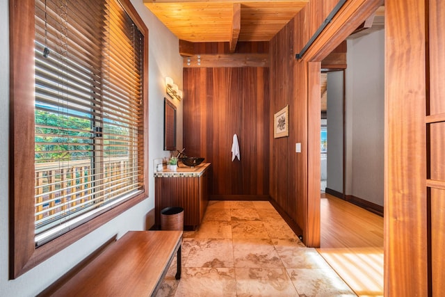 hall featuring wood walls and wood ceiling