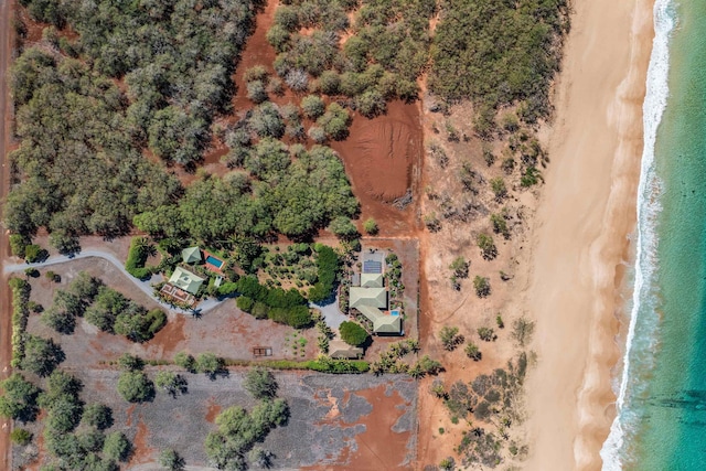 birds eye view of property with a view of the beach and a water view