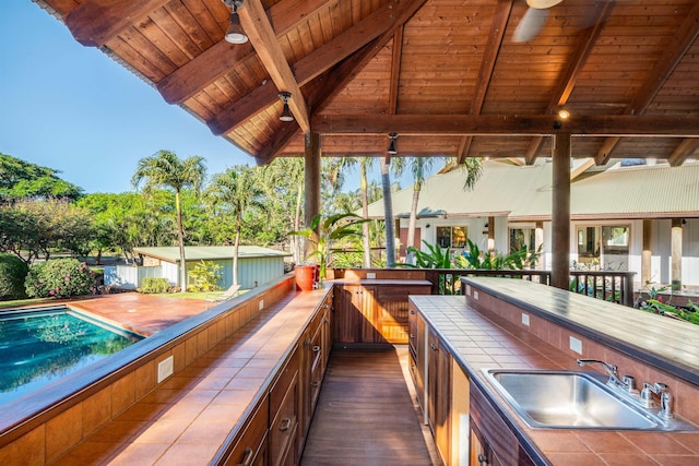 view of patio / terrace with a pool and an outdoor wet bar