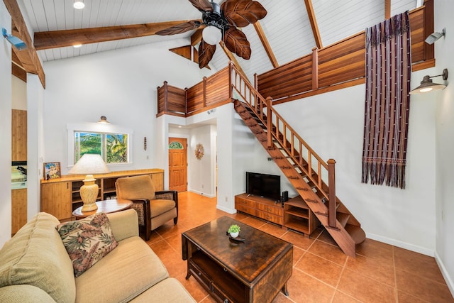 tiled living room with beamed ceiling, ceiling fan, wooden ceiling, and high vaulted ceiling