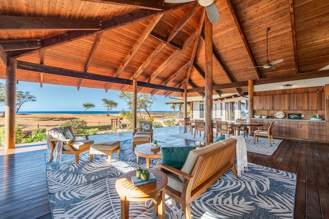 wooden terrace featuring a gazebo, a water view, and ceiling fan