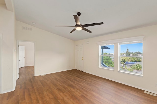 spare room featuring dark hardwood / wood-style flooring, ceiling fan, and lofted ceiling