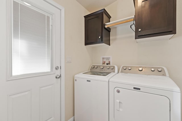laundry room with washing machine and dryer and cabinet space