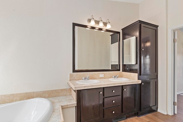 bathroom featuring a bathing tub, hardwood / wood-style floors, and vanity