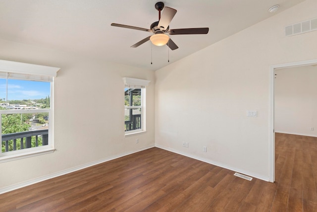 spare room with vaulted ceiling, ceiling fan, and dark hardwood / wood-style floors