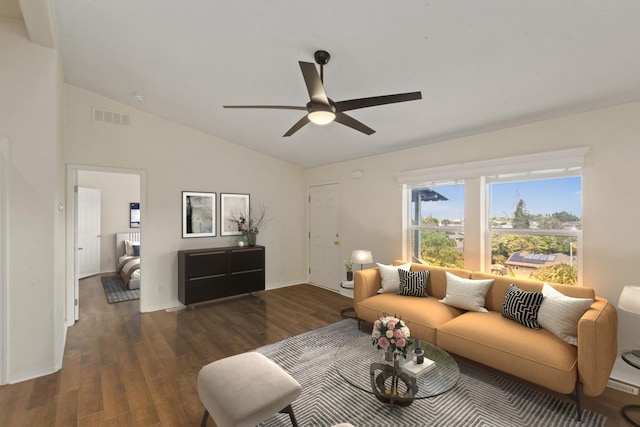 living area with visible vents, lofted ceiling, wood finished floors, baseboards, and a ceiling fan