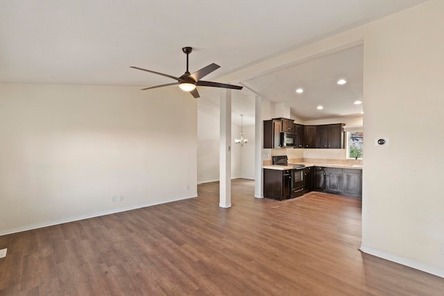 unfurnished living room with lofted ceiling with beams, sink, wood-type flooring, and ceiling fan with notable chandelier