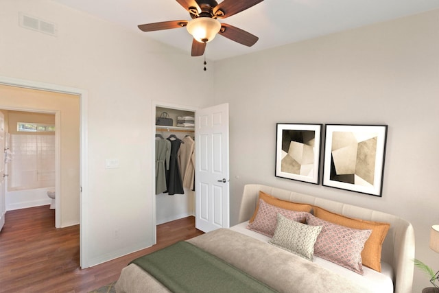bedroom featuring a ceiling fan, visible vents, wood finished floors, baseboards, and a closet