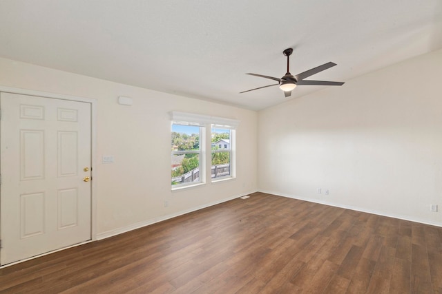 unfurnished room featuring dark hardwood / wood-style floors, vaulted ceiling, and ceiling fan