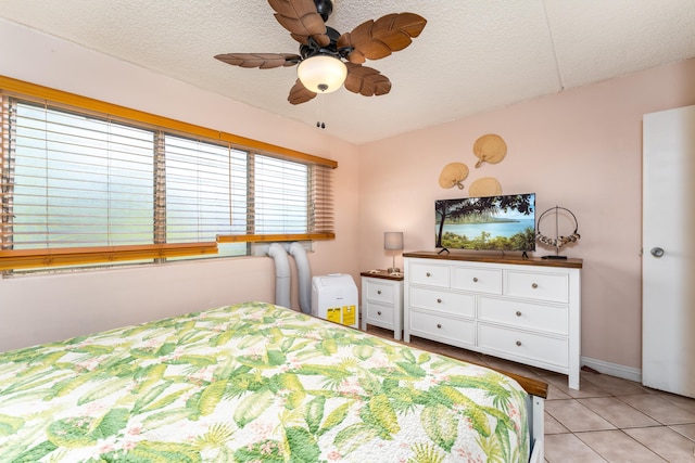 bedroom with light tile patterned flooring and a textured ceiling