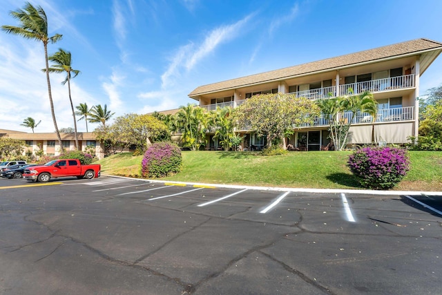 view of parking featuring a yard