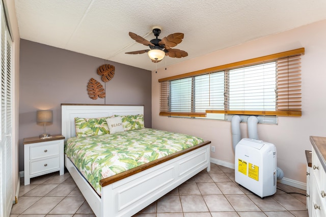 bedroom featuring light tile patterned floors and a textured ceiling