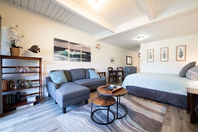 bedroom featuring wood-type flooring and beam ceiling