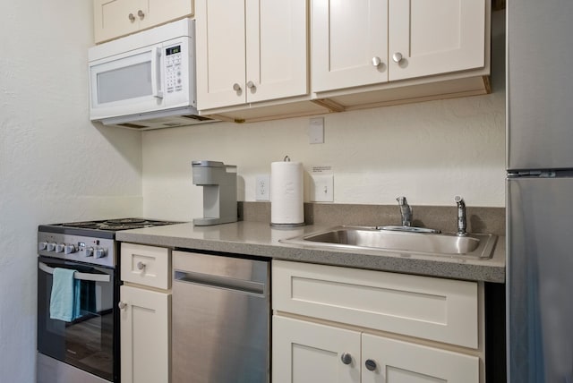 kitchen with white cabinets, sink, and stainless steel appliances