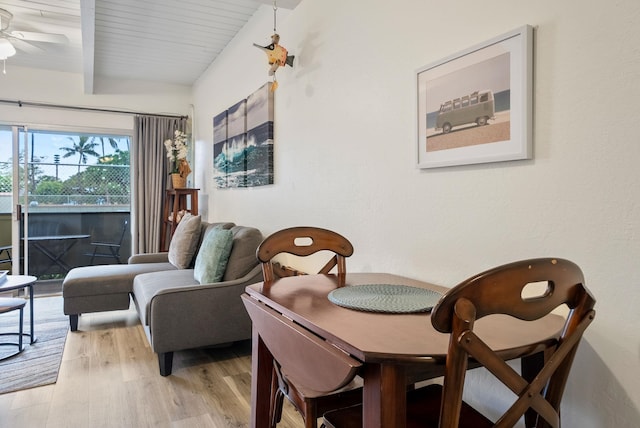 dining room with ceiling fan, hardwood / wood-style flooring, and beam ceiling