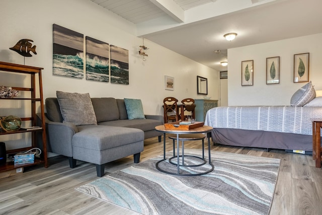 bedroom featuring wood-type flooring and beamed ceiling