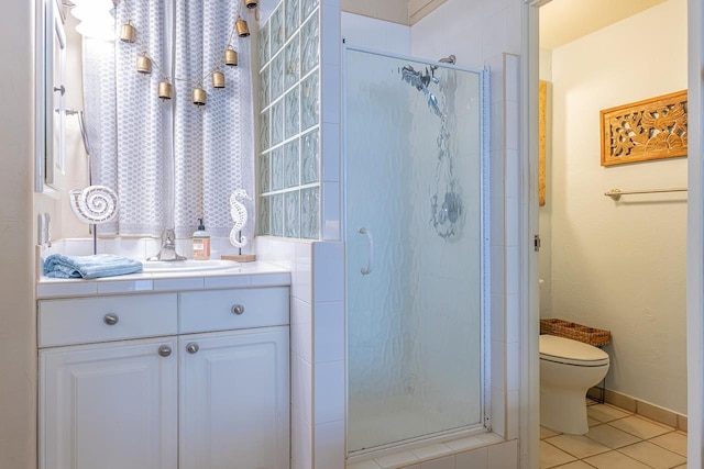 bathroom with vanity, tile patterned floors, a stall shower, and toilet