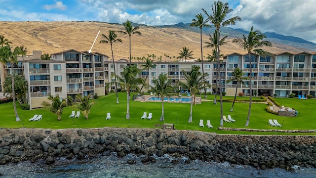 view of community featuring a lawn and a mountain view