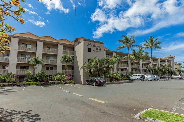 view of property featuring uncovered parking