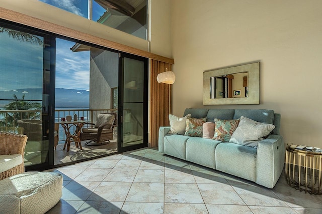 living room featuring tile patterned flooring and a towering ceiling