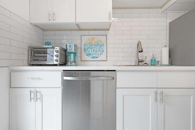 kitchen featuring backsplash, white cabinetry, and stainless steel dishwasher