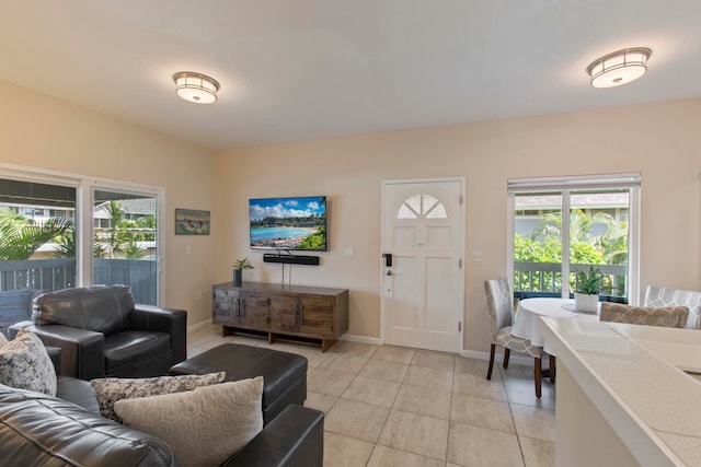160 Keonekai Rd Unit 11-201, Kihei, HI 96753 - living area with plenty of natural light, light tile patterned floors, and baseboards