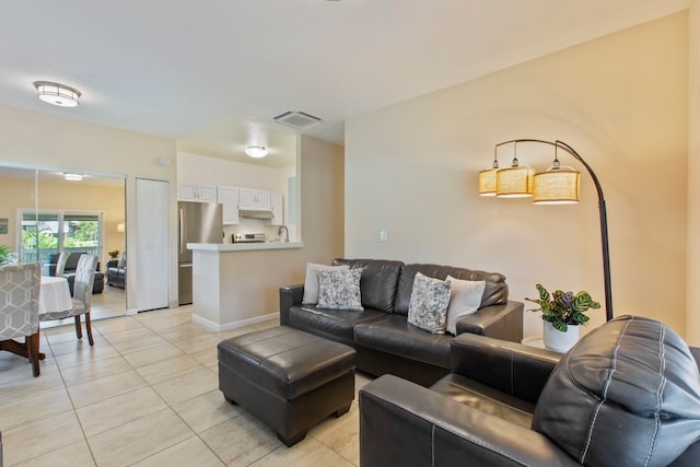160 Keonekai Rd Unit 11-201, Kihei, HI 96753 - living room featuring light tile patterned flooring and baseboards