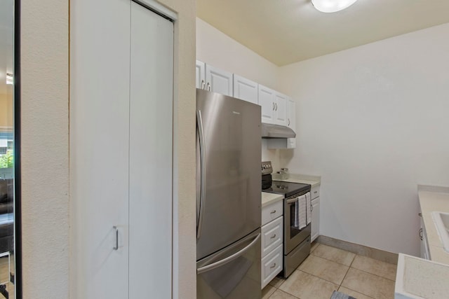 160 Keonekai Rd Unit 11-201, Kihei, HI 96753 - kitchen featuring appliances with stainless steel finishes, under cabinet range hood, light countertops, light tile patterned flooring, and white cabinets