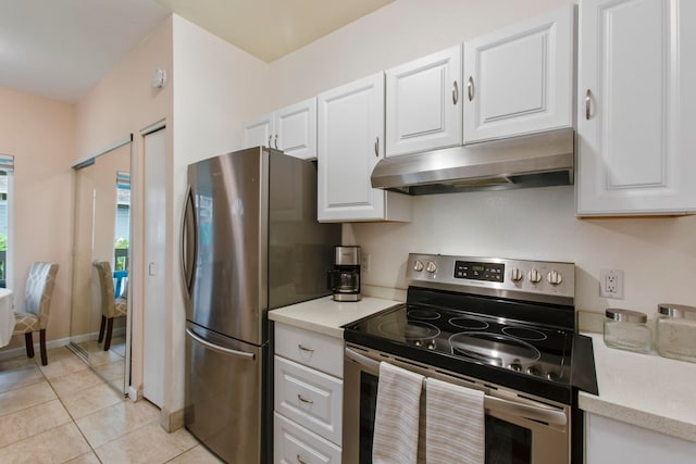 160 Keonekai Rd Unit 11-201, Kihei, HI 96753 - kitchen with stainless steel appliances, under cabinet range hood, white cabinetry, and light tile patterned floors