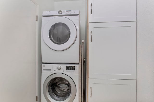 160 Keonekai Rd Unit 11-201, Kihei, HI 96753 - laundry room with stacked washer / drying machine and cabinet space