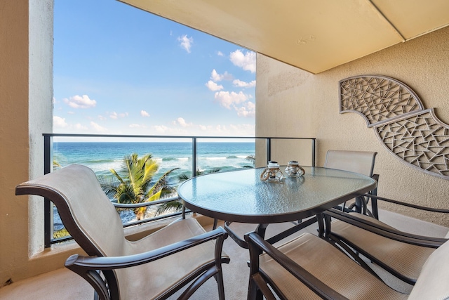 balcony with a view of the beach and a water view
