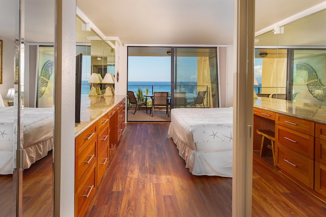 bedroom with access to exterior and dark wood-style flooring