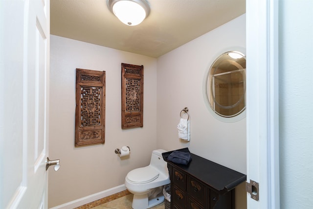 bathroom with toilet, tile patterned floors, and baseboards