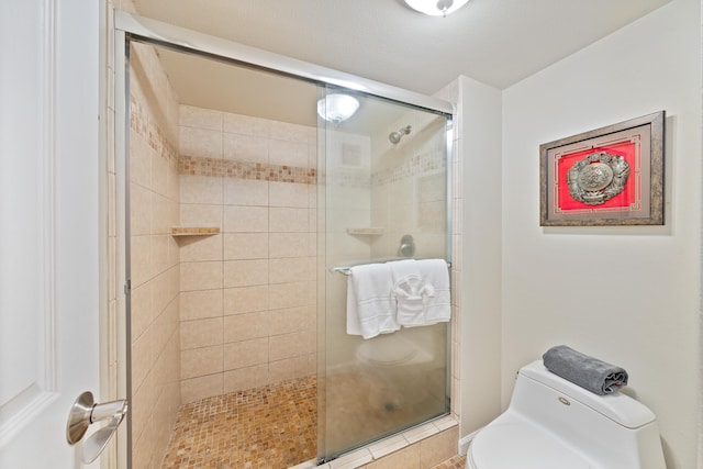 bathroom with toilet and a stall shower