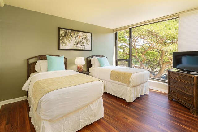 bedroom featuring wood finished floors and baseboards