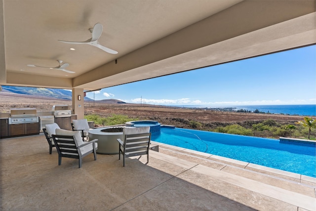 view of swimming pool featuring a grill, ceiling fan, exterior kitchen, and an in ground hot tub